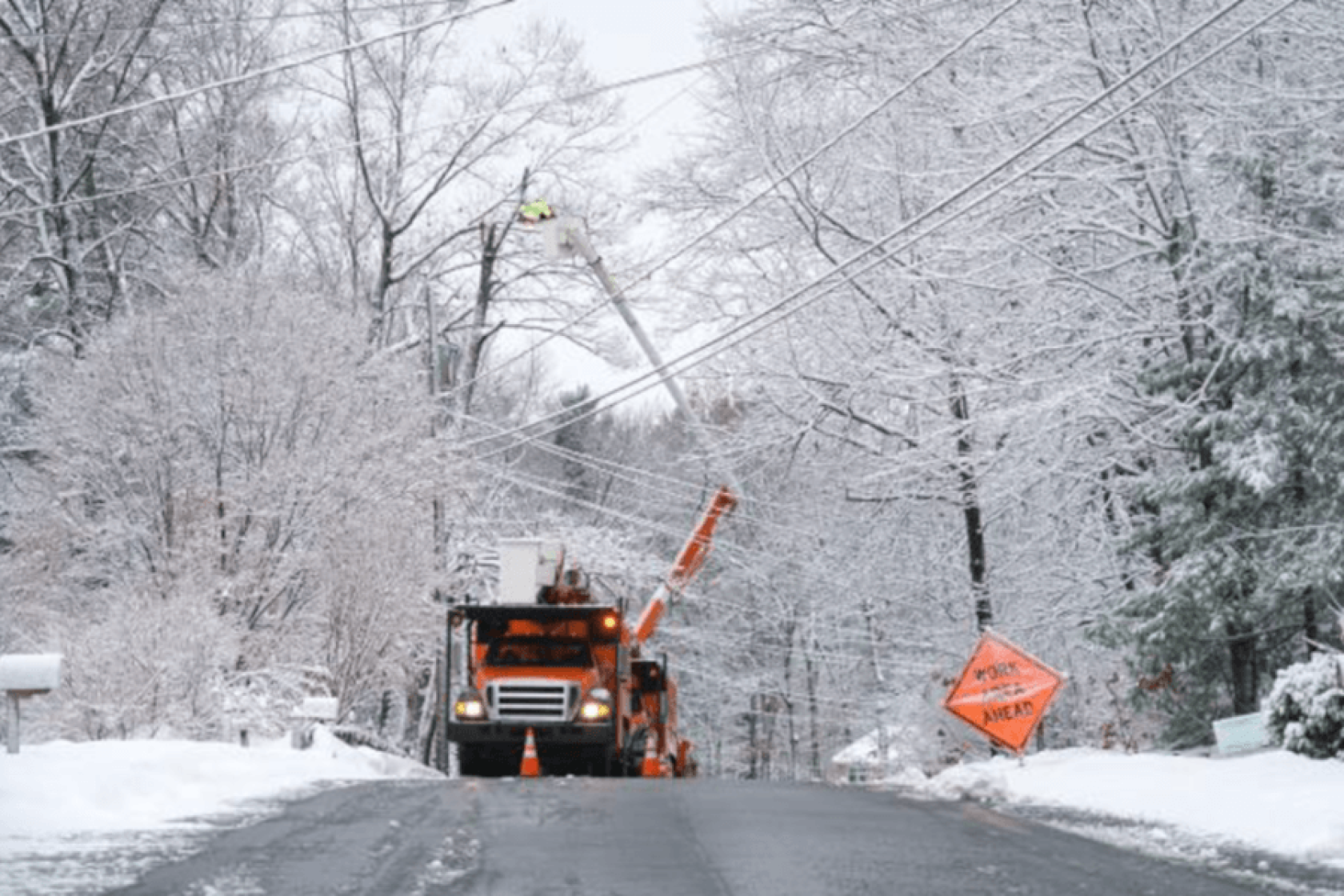 Energy worker tending to a power line during winter